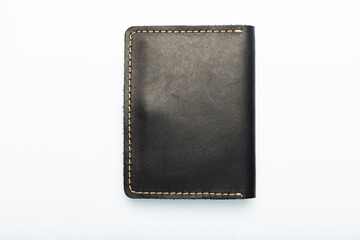 Black leather wallet on a button on a white background, wolf print. Top view