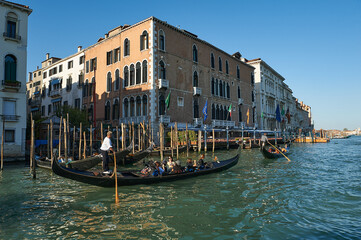 Fototapeta na wymiar Two gondolas carrying tourists along the Grand Canal at Venice