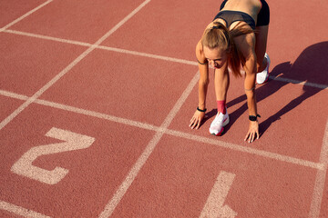Woman getting ready to start on Stadium - summer outdoors training.