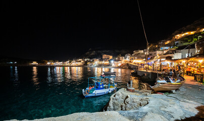 Night view of Matala village restaurants in Crete, Greece.