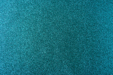 Background with sparkles. Backdrop with glitter. Shiny textured surface. Dark cyan