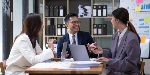 Group of young asian modern people in smart casual wear having a brainstorm meeting. Group of young asian business people discussing in the meeting.