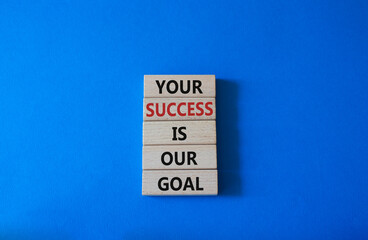 Your success is our goal symbol. Wooden blocks with words Your success is our goal. Beautiful blue background. Business and Your success is our goal concept. Copy space