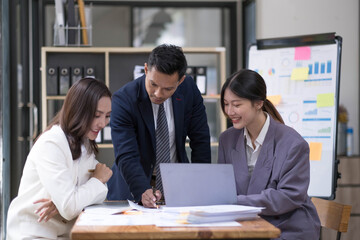 Group of young asian modern people in smart casual wear having a brainstorm meeting. Group of young asian business people discussing in the meeting.