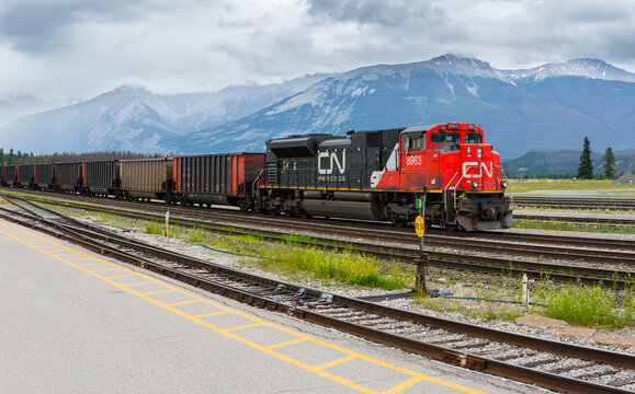 Canadian National CN Rail train engine transport pulling cargo through beautiful Canadian Rockies landscape on July 9, 2020 in Jasper, Alberta, Canada