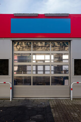 Front shot of abandoned car wash store with empty or blank sign in Germany.