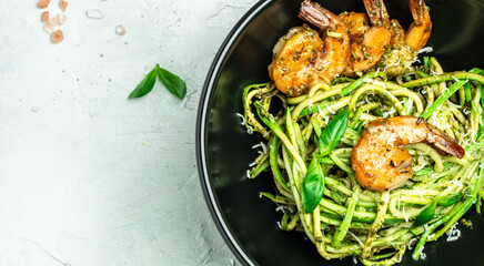 Zucchini raw pasta with pesto sauce and grilled shrimp cheese Parmesan, Restaurant menu, dieting, cookbook recipe top view
