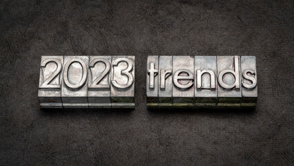 Fototapeta na wymiar 2023 trends in grunge metal type against colorful marbled paper, business year prediction concept