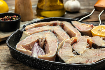 the chef holds steaks of large raw sturgeon fish. Culinary, cooking, bakery concept