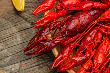 Red crayfish with lemon on a wooden background. banner, menu, recipe place for text, top view