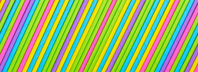 Close up many colored paper straw pattern background. Flat lay cocktail tube abstract vertical line texture