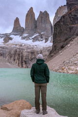 person on the top of the mountain, in front of the lagoon, base del torres, Torres del Paine