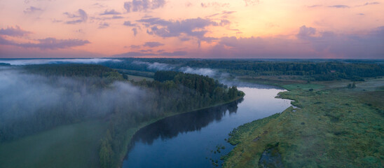 Aerial panoramic landscape with sunset over the river with islands and beautiful clouds on the sky.