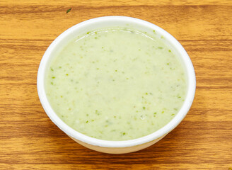 Mint raita chutney served in plate isolated on table top view of indian and pakistani spicy food