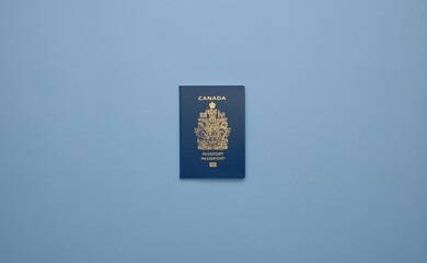 A Canadian passport against a solid light blue background