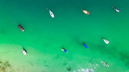 Boats from air. Aerial view on lake. Summer seascape with clear water in sunny day.