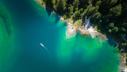 Beautiful top view of a lake surrounded by forest in Gosausee, Austria