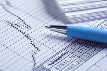 Accounting document with pen, share listing and checking financial chart. Concept of banking, financial report and financial audit.