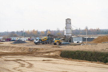 A concrete mixer stands at a modern concrete plant on loading