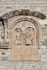 Religious medieval sculptures on the wall of an ancient cathedral in Rapolla, a small town in southern Italy.