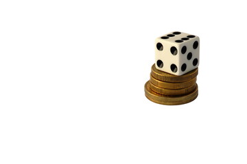 Dice on top of a pile with golden coins. Isolated on a white background.