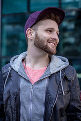 Fototapeta premium Male fashion model enjoying the city. Young beard caucasian man.