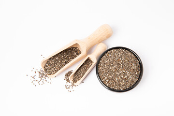 Chia seeds in bowl and wooden spoons isolated on white background.Superfood