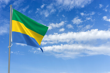 Gabonese Republic Flag Over Blue Sky Background. 3D Illustration