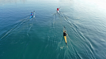 Aerial drone abstract slow shutter photo of athletes competing in sport canoe in tropical exotic...