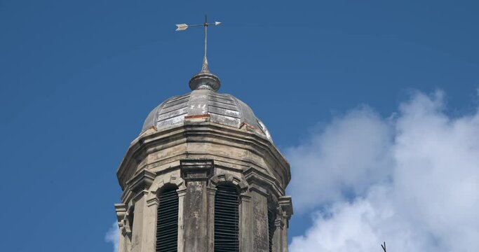 Antigua Caribbean St Johns Cathedral cross tower clouds fast. Church of Diocese North Eastern Caribbean and Aruba. Anglican Church of England. Originally built 1683. Seventy foot twin towers.