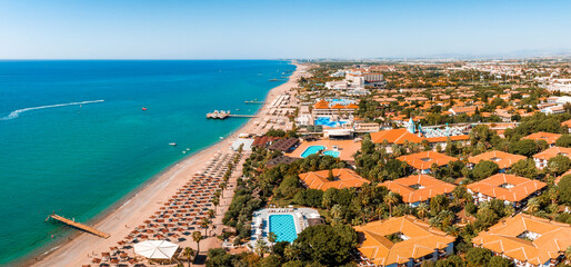 Luxury tropical hotel resort. Outdoor tourism landscape. Luxurious beach resort with bungalows in the park by the beach.