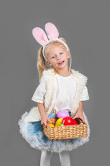 Happy easter. Girl with basket for Easter eggs and rabbit ears
