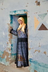 Nubian girl stands in front of Nubian house door in aswan,Egypt