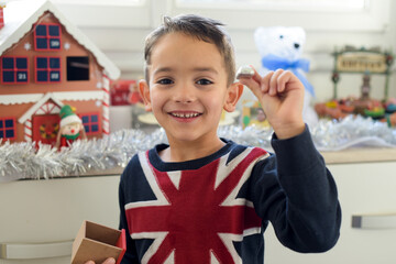 young caucasian boy who has found a surprise in the advent calendar