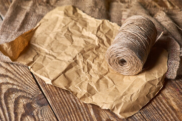 Old paper and packthread on the wood table background