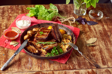 Roasted pork ribs with grilled vegetables in a pan. Meat grilled close up