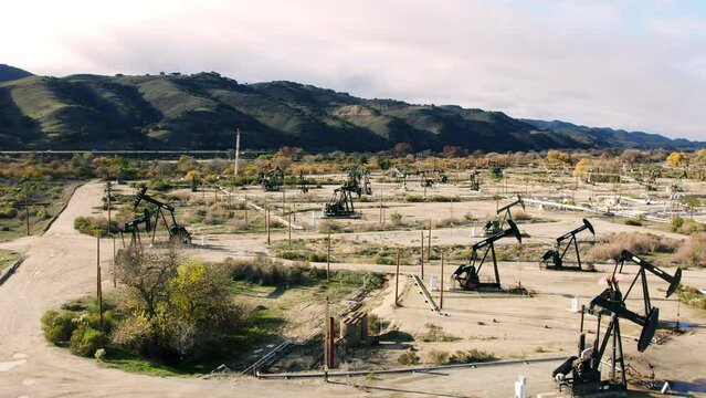 Rotating around pumpjacks drilling oil 