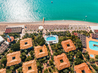 Luxury tropical hotel resort. Outdoor tourism landscape. Luxurious beach resort with bungalows in the park by the beach.