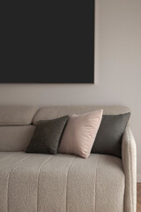 Close up light fabric sofa with pillows in warm cozy home interior background. Room decoration concept.