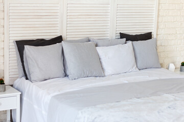 Gentle interior of bedroom is in light colors, there is a bed with pillows and a covering. Great usual place to sleep