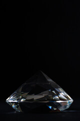 Glass crystal on a black background with faces