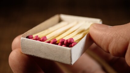 Accelerated shooting. One match burns out against the background of a wooden table. The texture of the tree. Match Flame