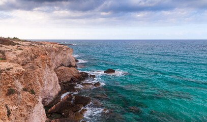 Fototapeta na wymiar Coastal rocks of Mediterranean Sea. Summer view of Ayia Napa, Cyprus