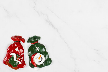 Two bags of Santa Claus with gifts. Christmas sweets covered with colored icing sugar. White background. Top view. Copy space