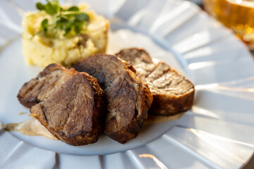 Pork neck fillet and mashed potatoes on the plate