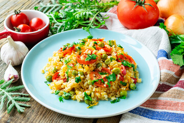 Bulgur with carrots, onions, bell peppers and green peas