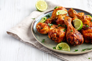 Homemade Grilled Jerk Chicken with Lime on a Plate, low angle view. Copy space.