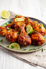 Homemade Grilled Jerk Chicken with Lime on a Plate, low angle view.