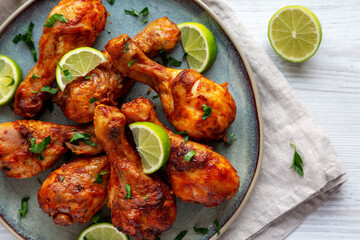 Homemade Grilled Jerk Chicken with Lime on a Plate, top view. Flat lay, overhead, from above.