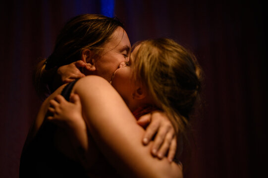 Portrait Of A Mother With Her Daughter In Each Other's Arms.